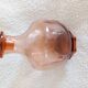 Vintage glass carafe in pink-orange, retro-chic style.