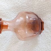 Vintage glass carafe in pink-orange, retro-chic style.