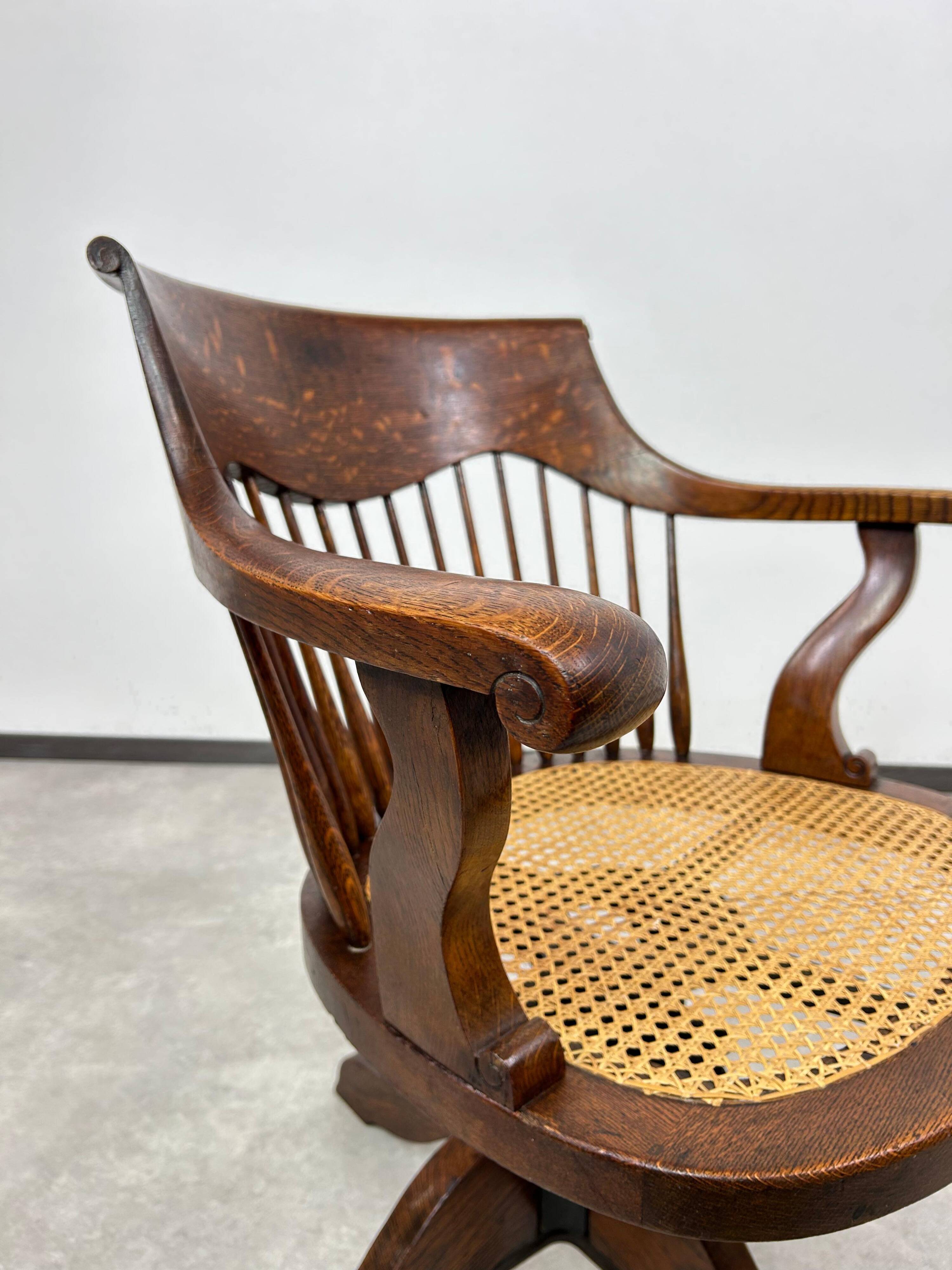 Swivel office chair in oak with a rattan seat.