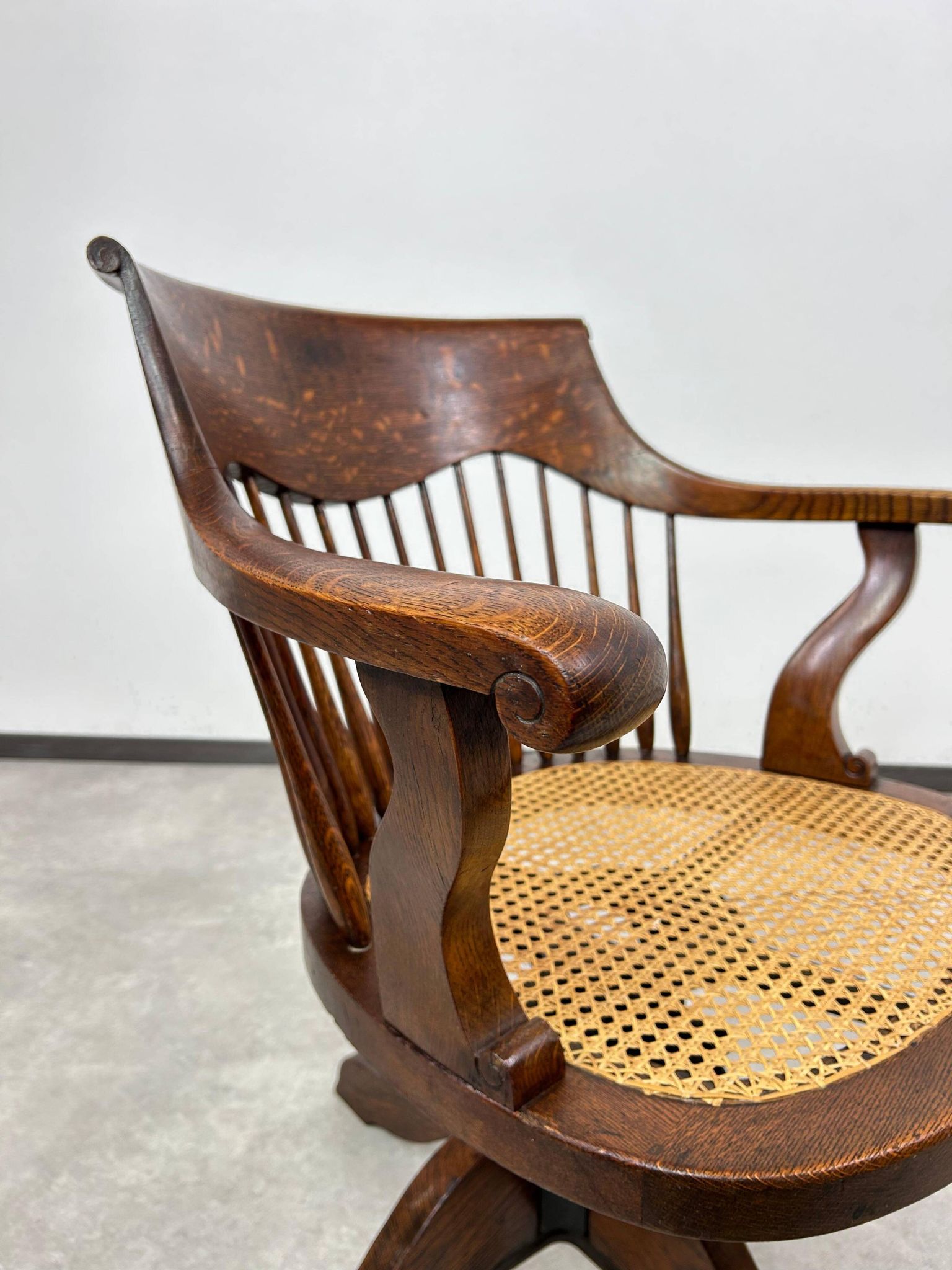 Swivel office chair in oak with a rattan seat.
