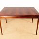 Danish extendable dining table in rosewood and brass by Poul Volther