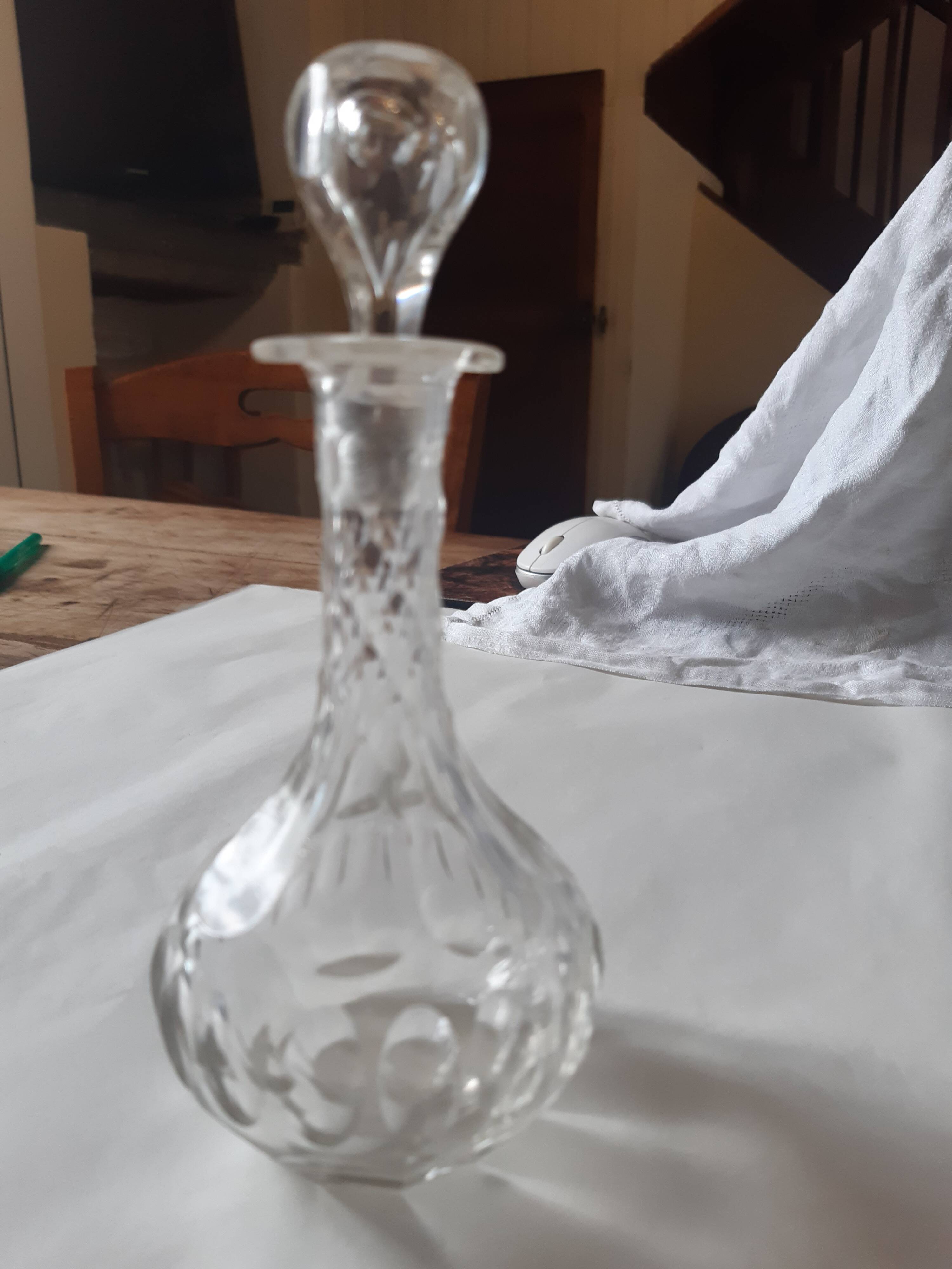 Cut crystal oil bottle with its crystal stopper.