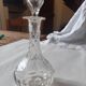 Cut crystal oil bottle with its crystal stopper.