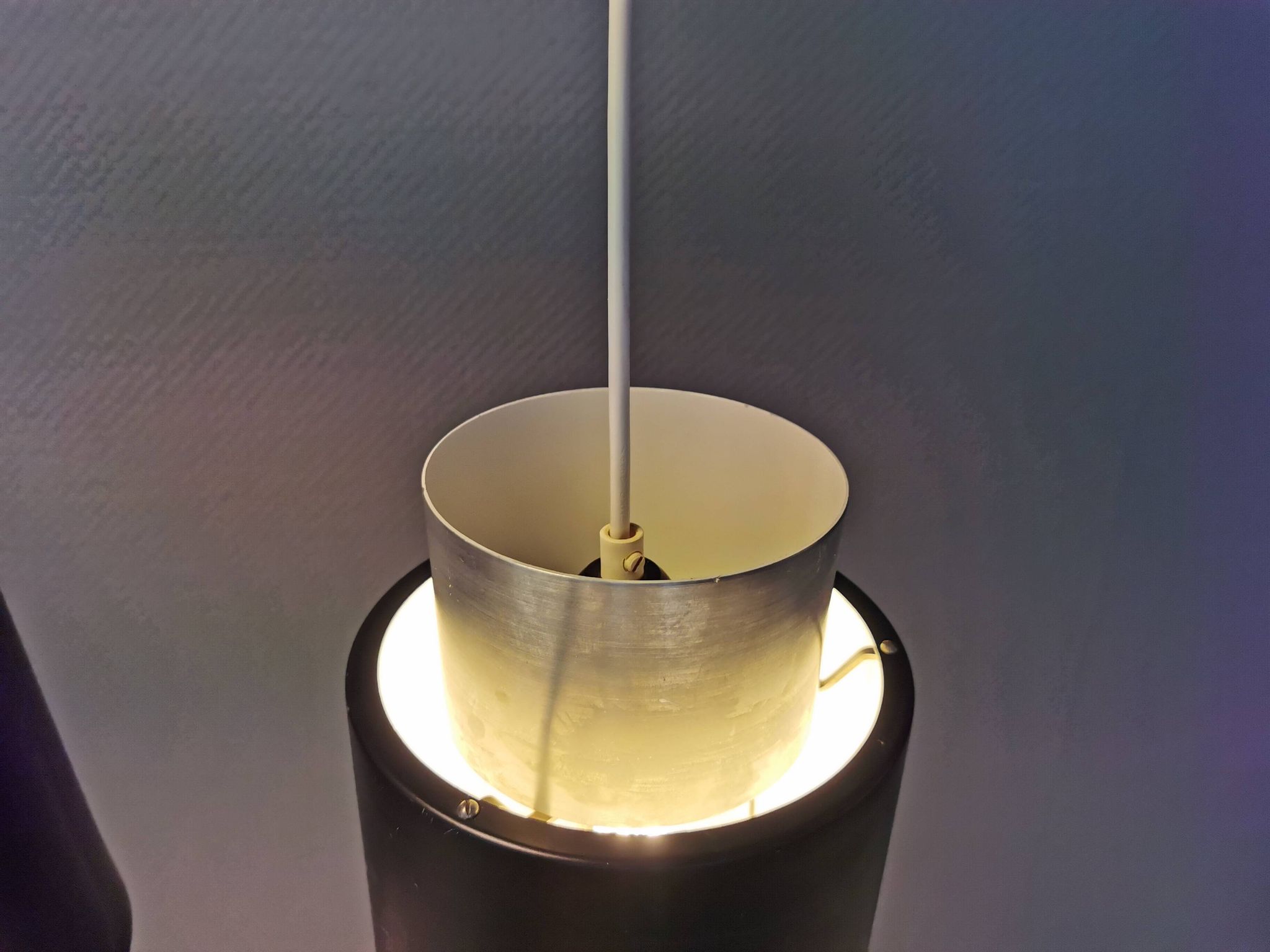 A set of beautiful cylinder shaped hanging lamps in silver color with black "ring" Danish 1970s.