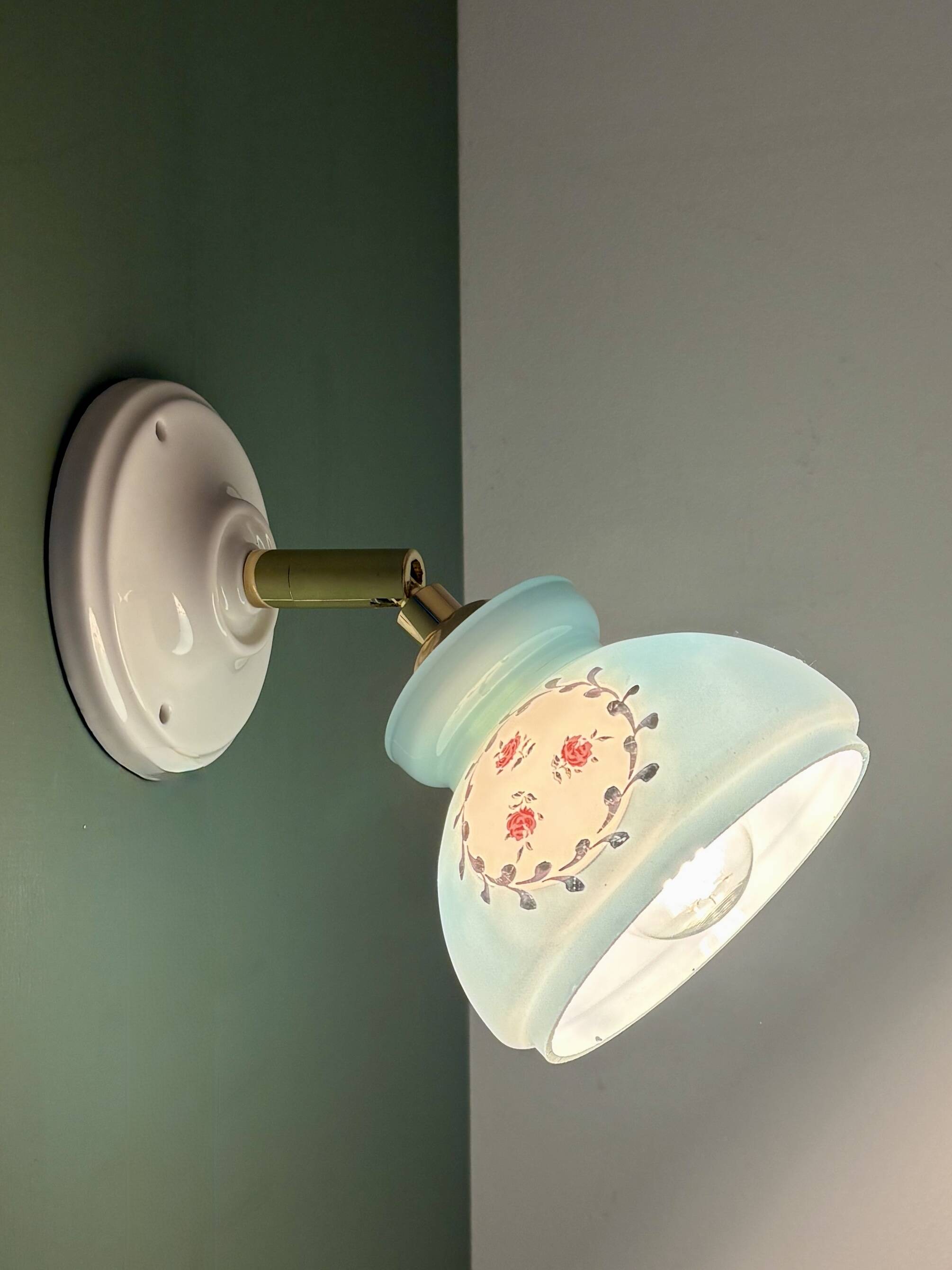 Vintage wall sconce with blue opaline glass shade and floral decorations