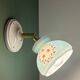 Vintage wall sconce with blue opaline glass shade and floral decorations