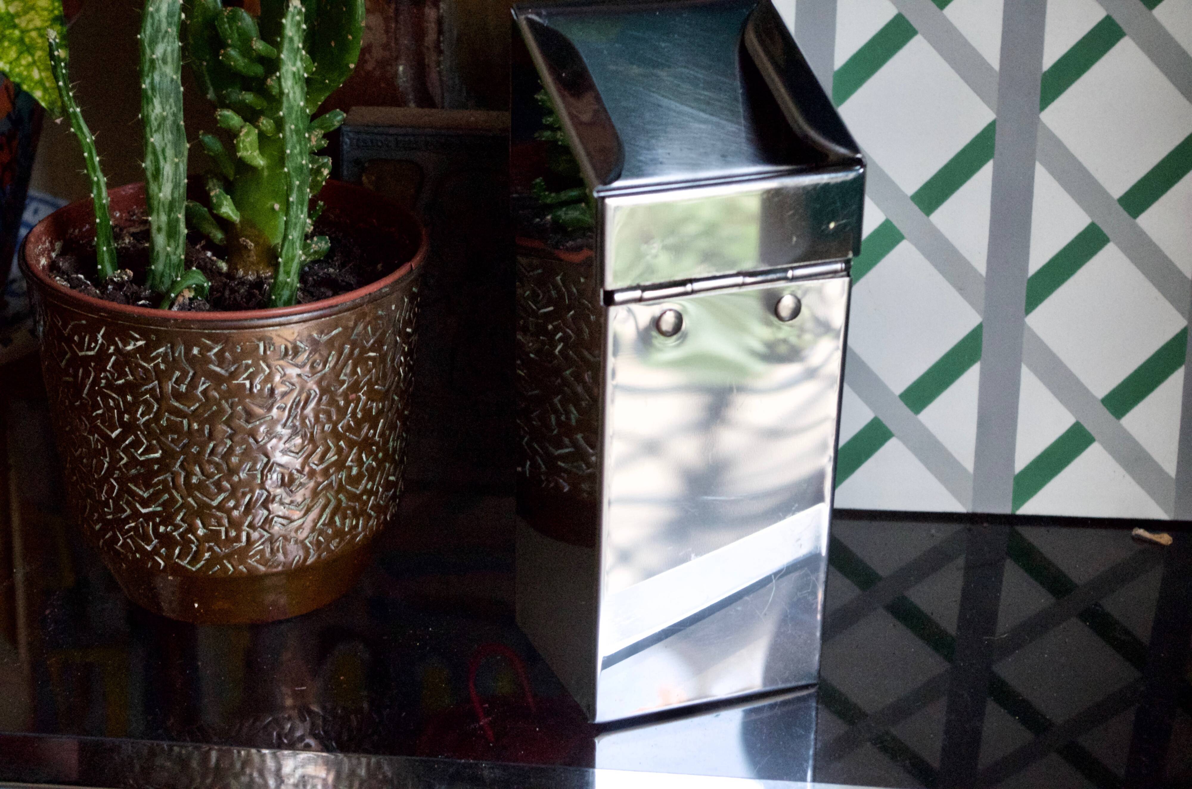 Vintage wall ashtray in shiny metal industrial style