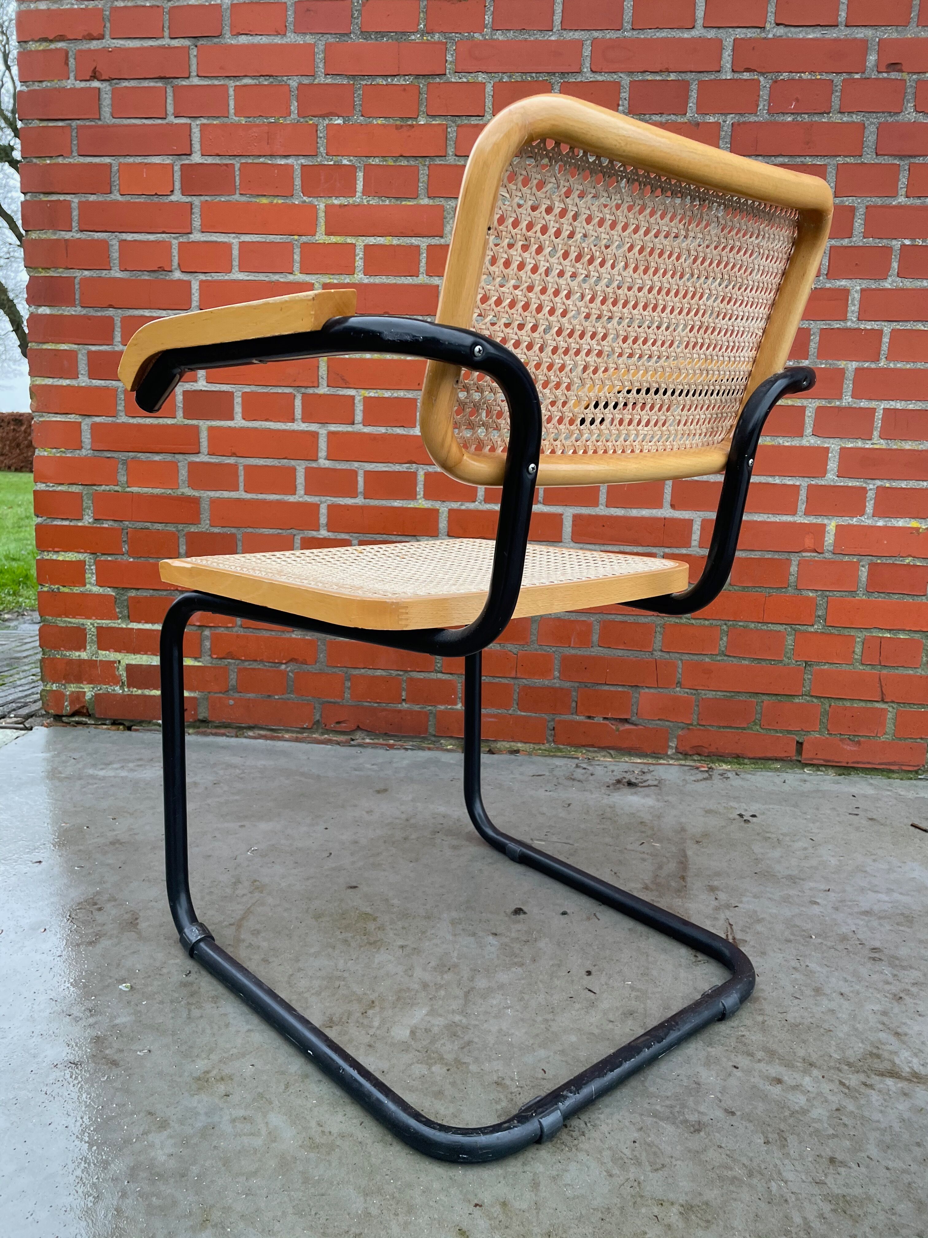 Cesca model chair designed by Marcel Breuer with black-framed armrests