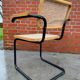 Cesca model chair designed by Marcel Breuer with black-framed armrests
