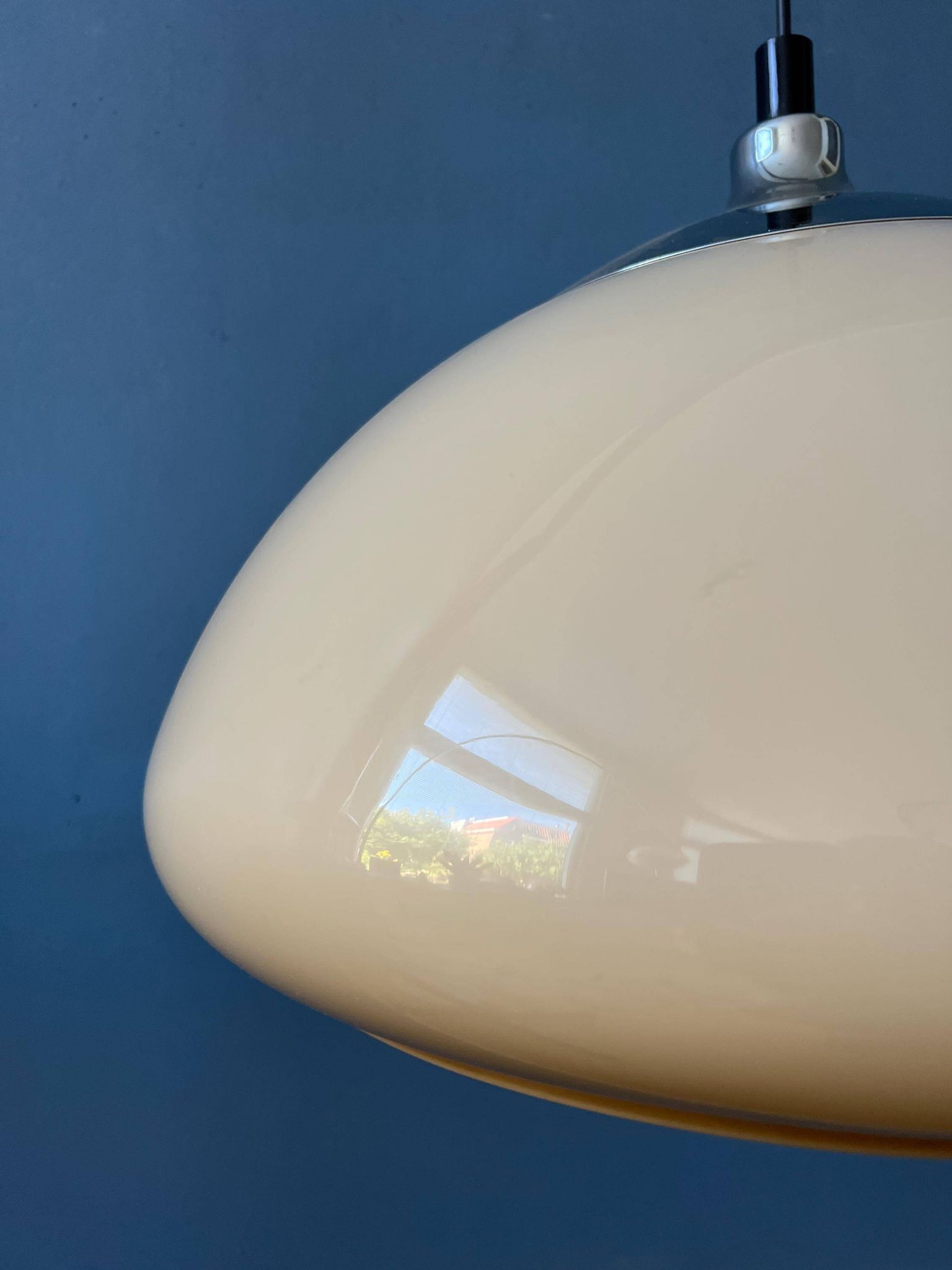Beige acrylic glass mushroom pendant with a chrome top cap.