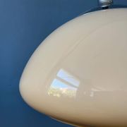 Beige acrylic glass mushroom pendant with a chrome top cap.