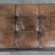 Beautiful sheepskin ottoman on high legs and beautiful warm colours