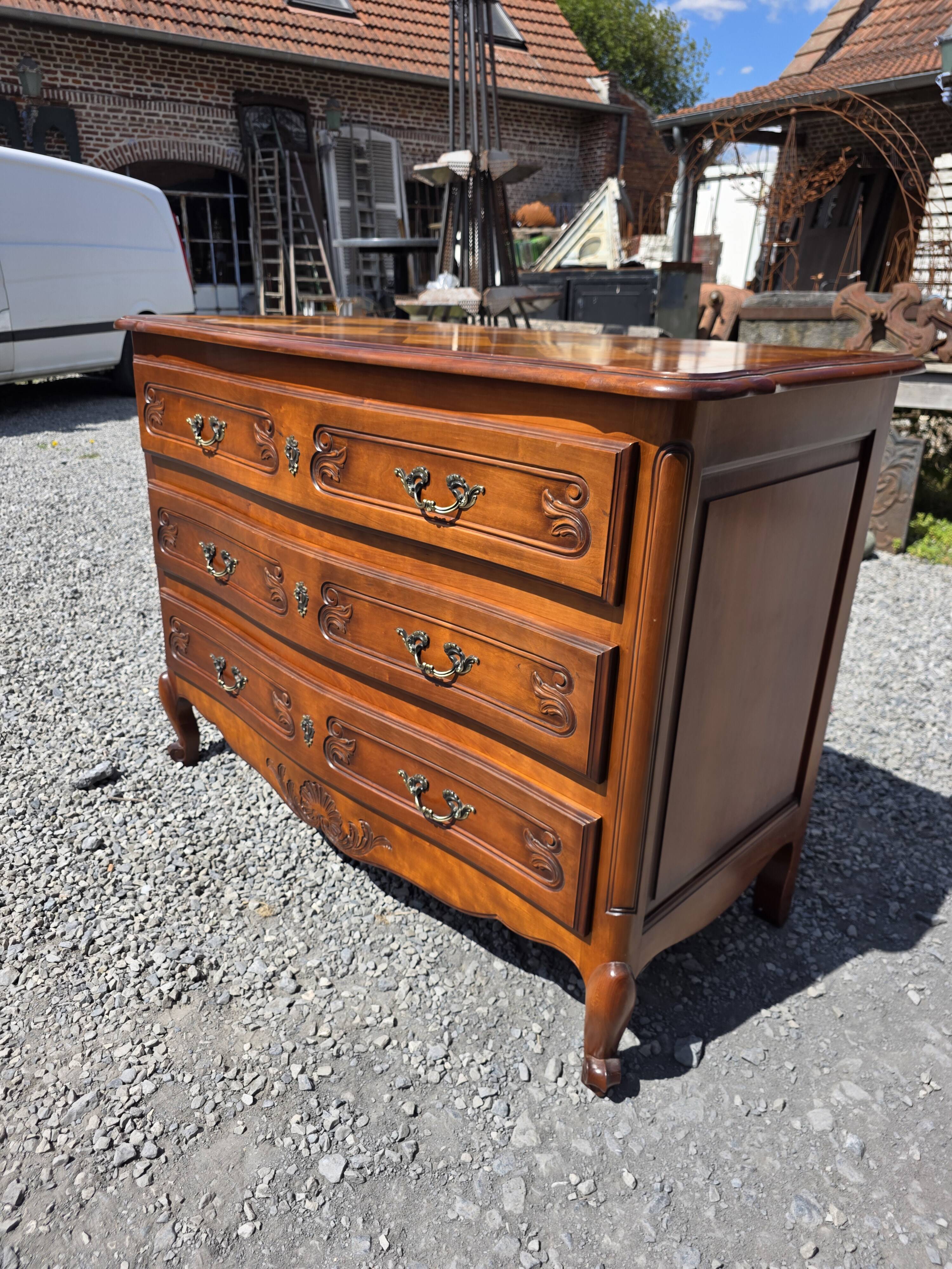 Curved commode in Louis XV style made of cherry wood.