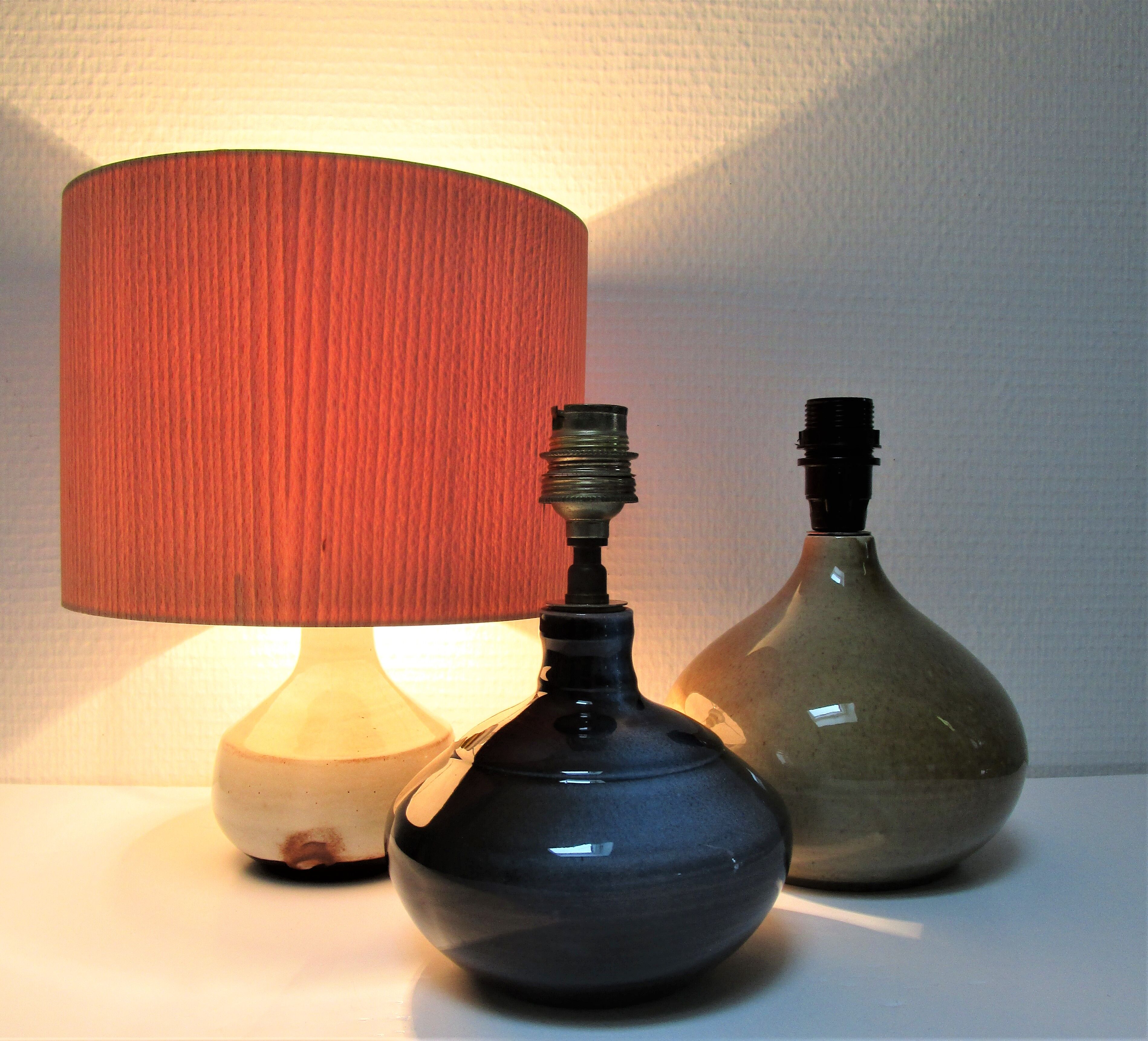 Three vintage ceramic lamps in blue, white and suede