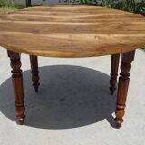 Round drop-leaf table made entirely of solid walnut