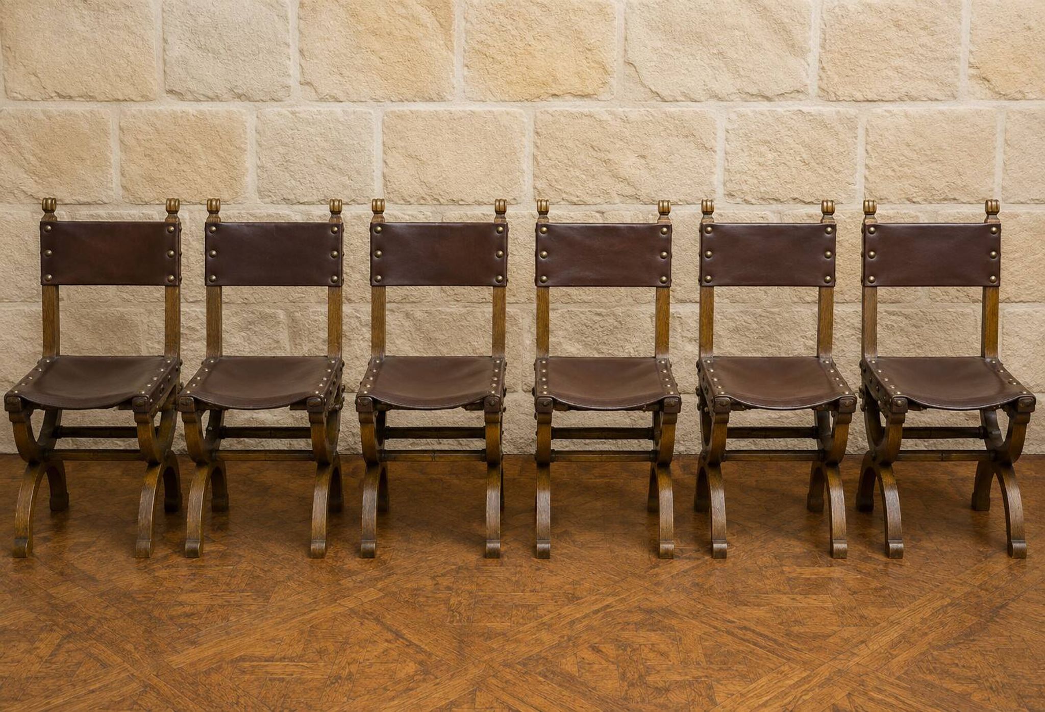 Set of six Renaissance-style chairs in oak and leather.