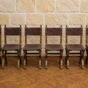 Set of six Renaissance-style chairs in oak and leather.