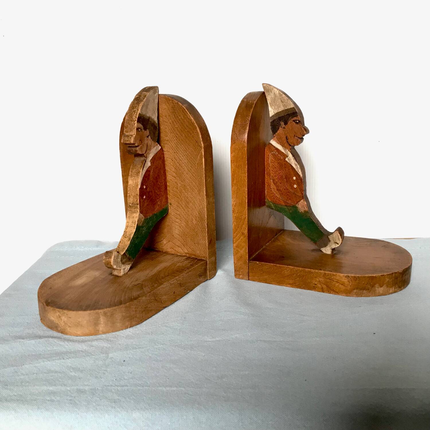 Old wooden bookends with painted characters