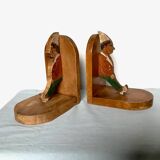 Old wooden bookends with painted characters