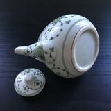 Green plant-decorated teapot