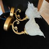 Frosted glass tulip wall sconces with brass arms.