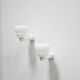 Pair of art deco porcelain and glass wall appliques