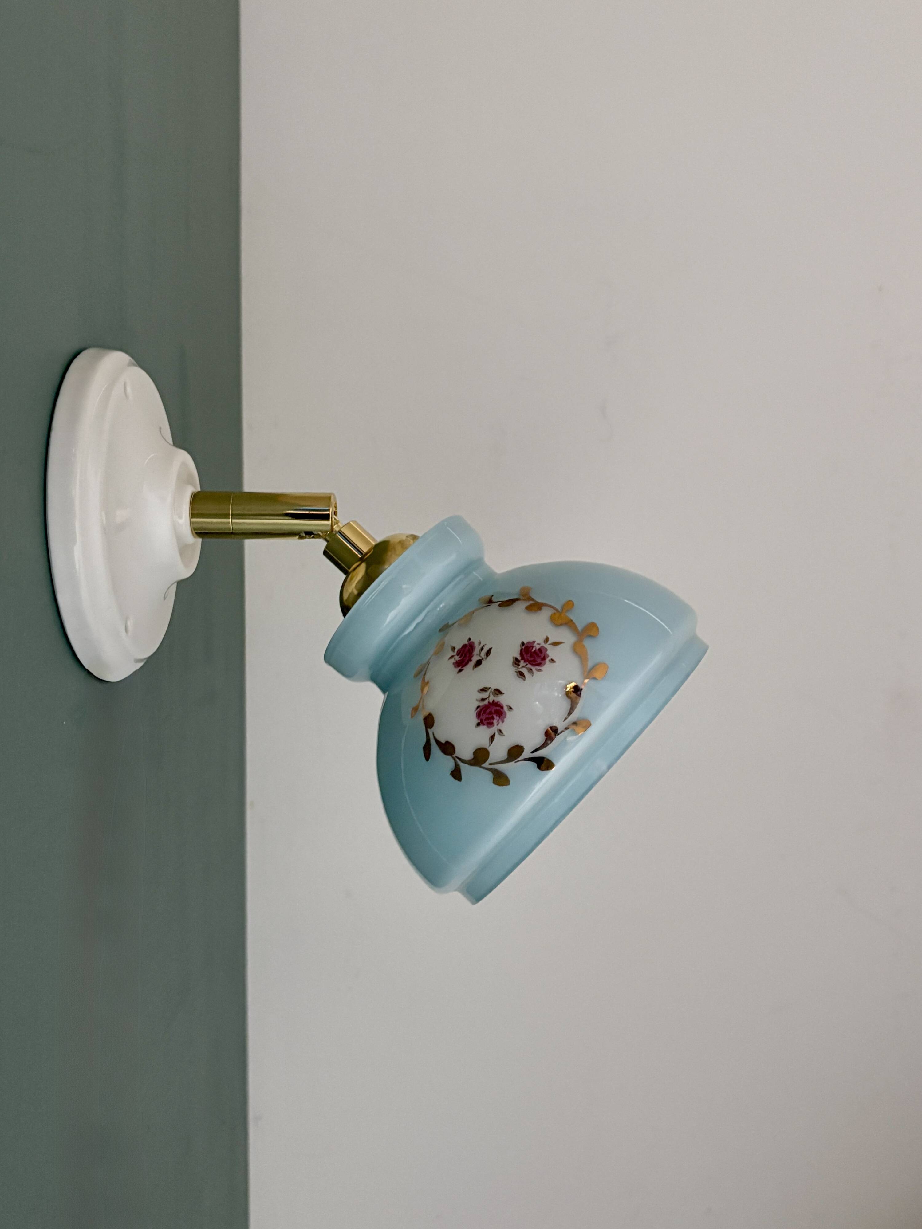 Vintage wall sconce with blue opaline glass shade and floral decorations