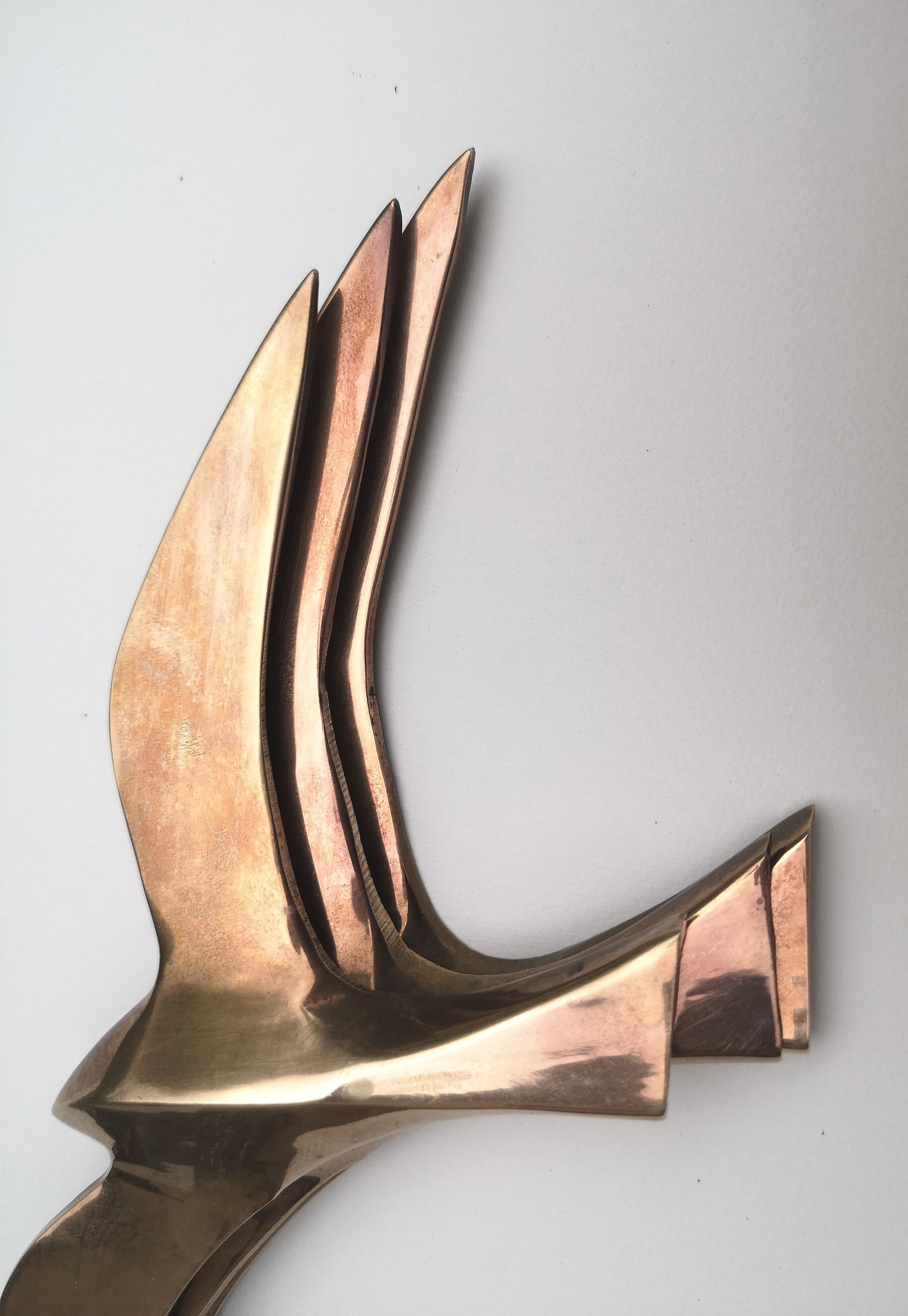 Birds stylized in brass