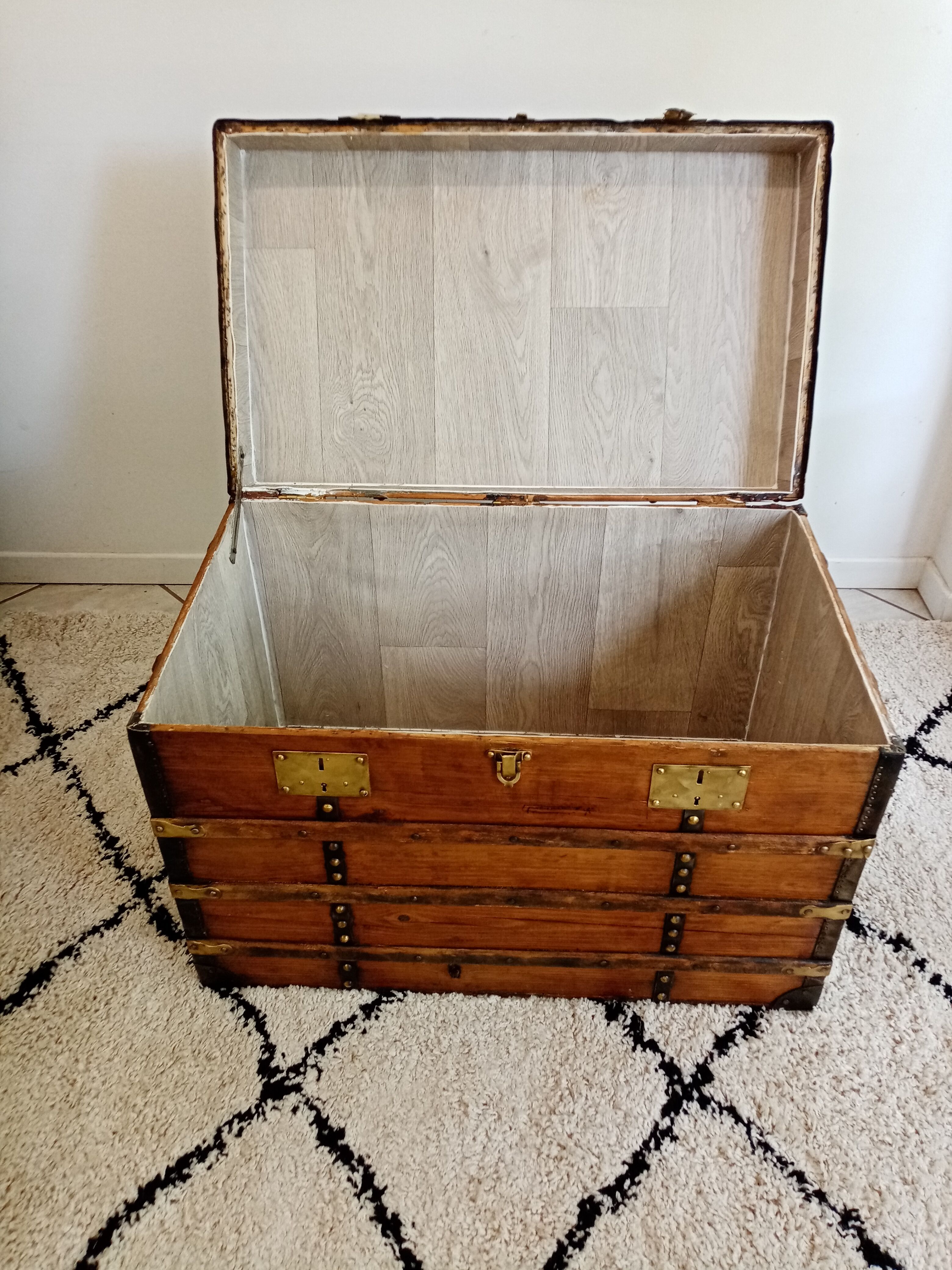 Restored varnished wooden antique travel trunk