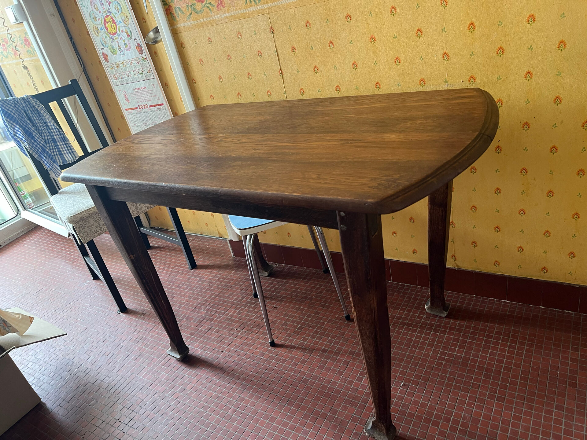 Vintage antique oak table with ornate legs.