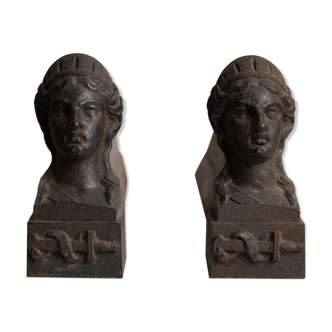 Pair of ancient cast iron chenets adorned with bust of Marianne