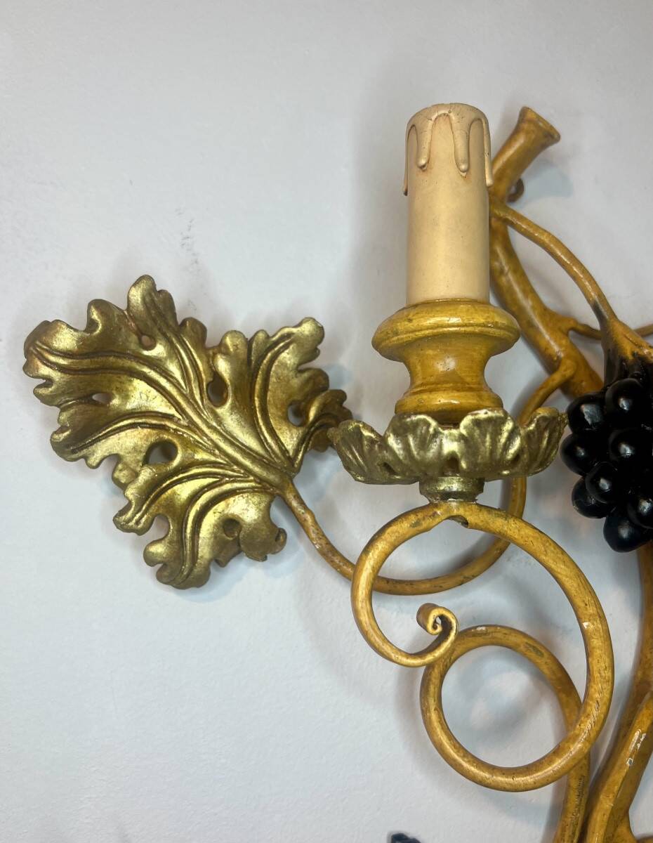 Large pair of wall sconces with vine decorations.