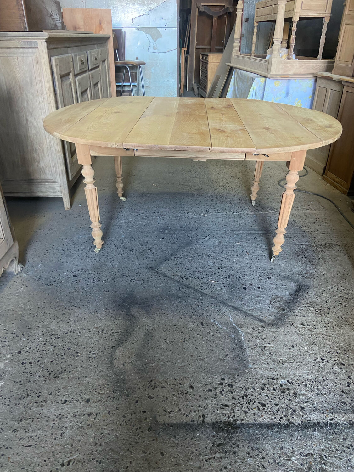 Oval wooden table on wheels.