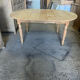 Oval wooden table on wheels.