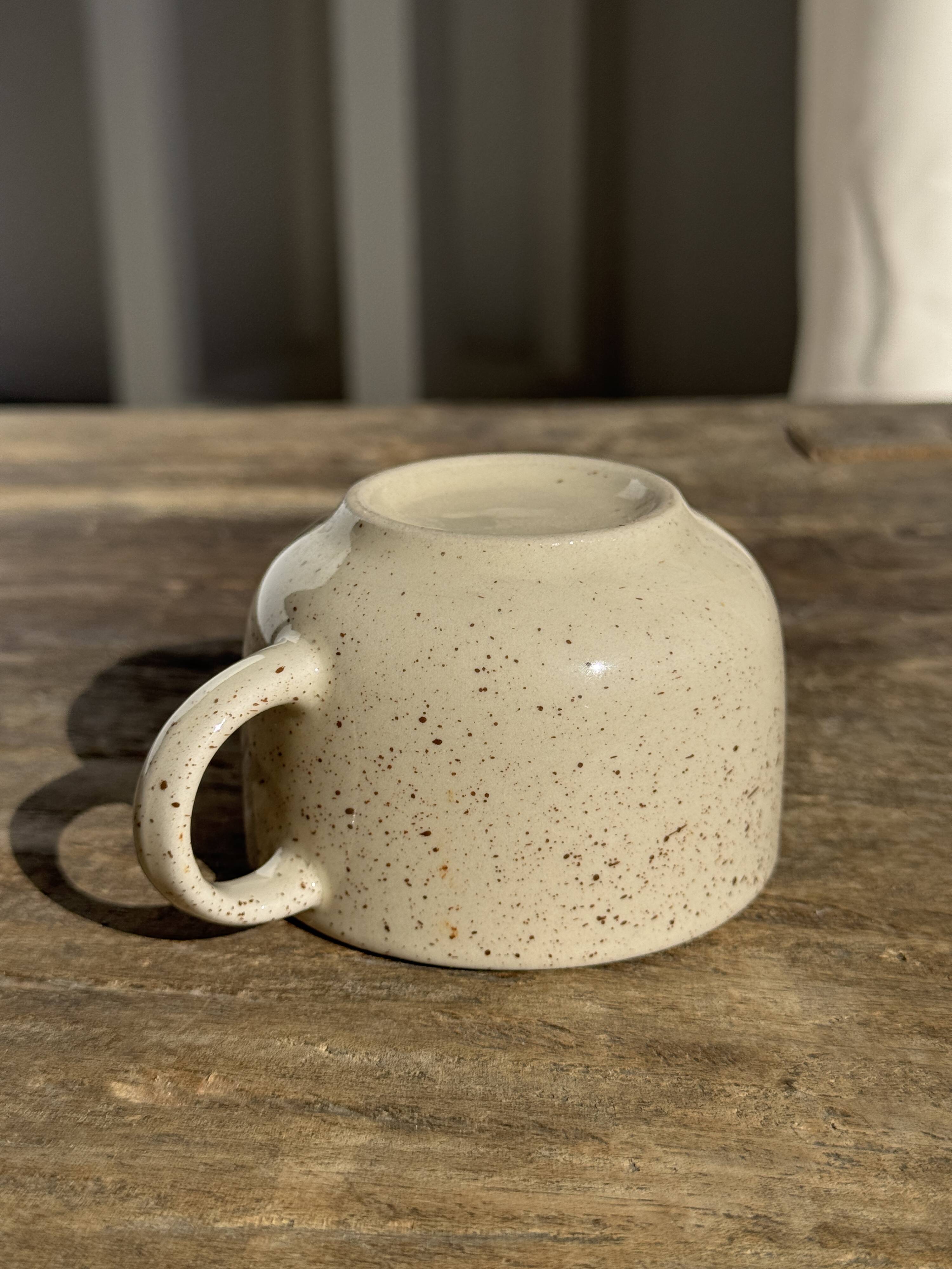 Set of 4 vintage speckled beige stoneware coffee cups.
