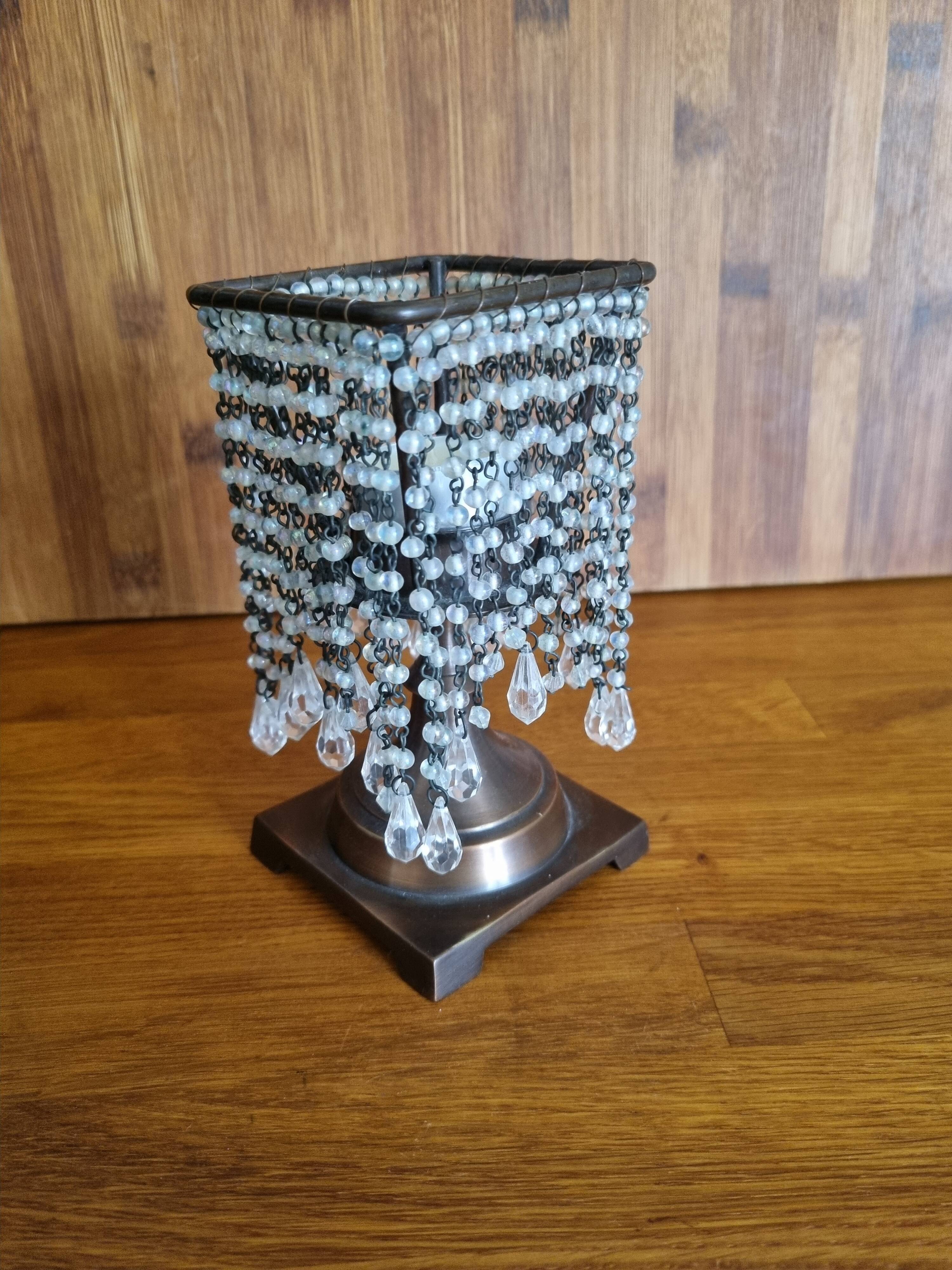 Metal candle holder with white glass tassels