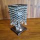 Metal candle holder with white glass tassels