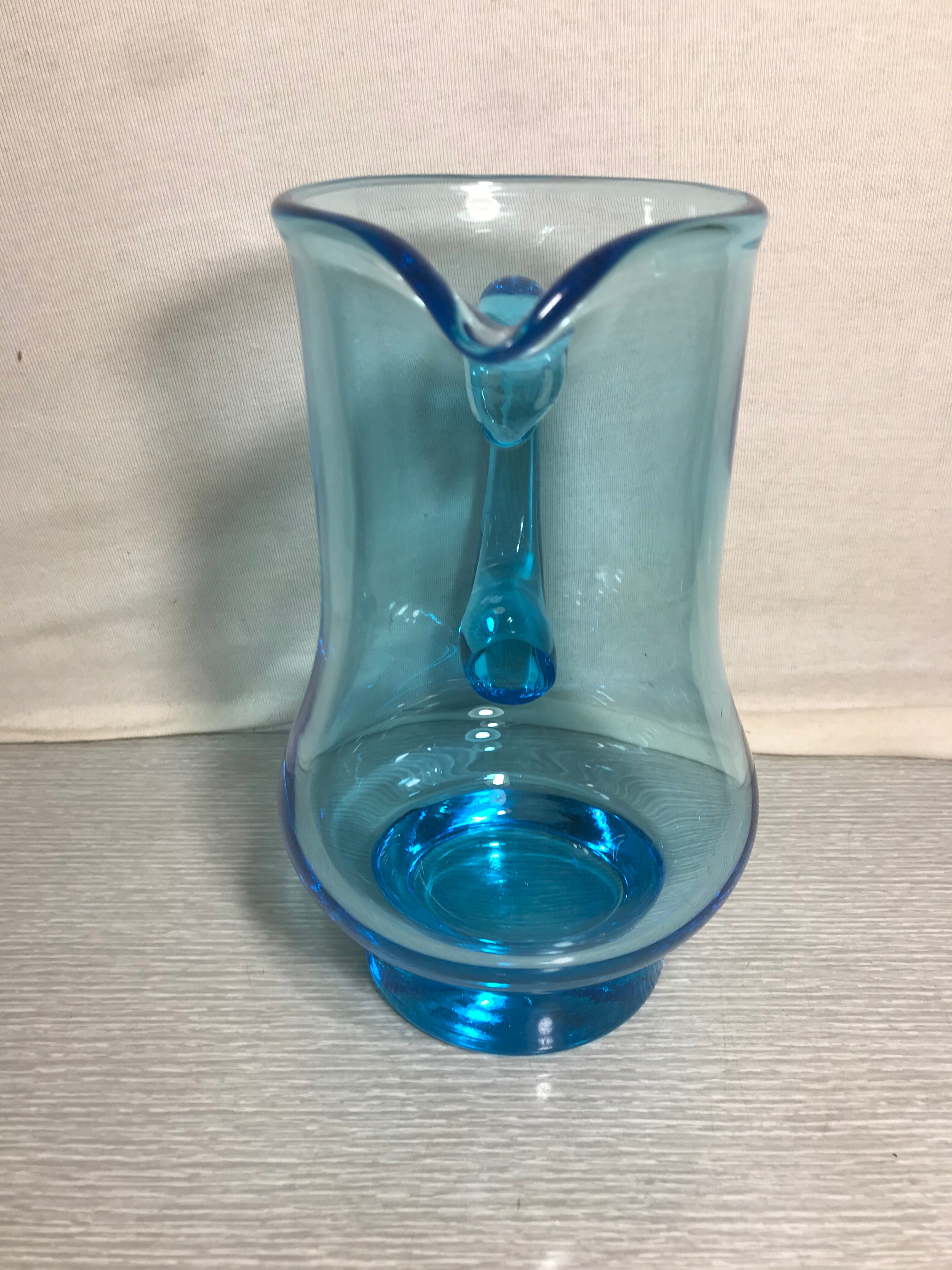 Old blue blown glass pitcher with vintage handle