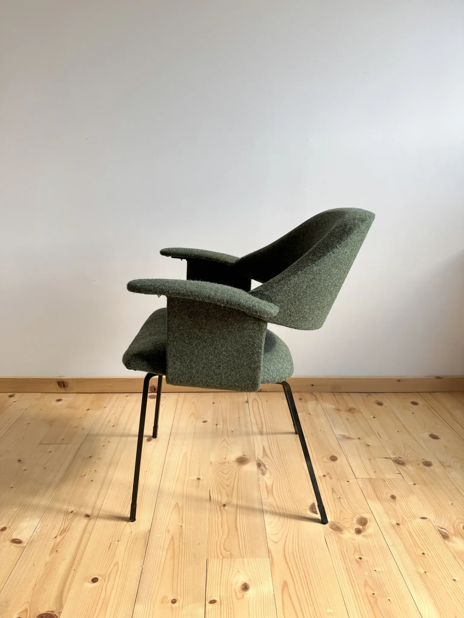 Curved vintage wool armchair from the 1960s