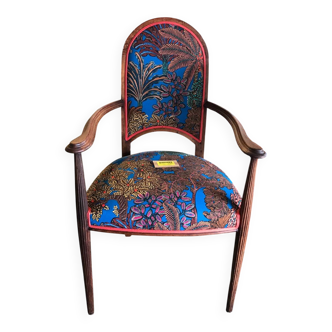 Art Nouveau armchair with a floral seat and backrest.