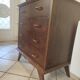 Vintage chest of drawers from the 1950s with wooden legs and a design feature.