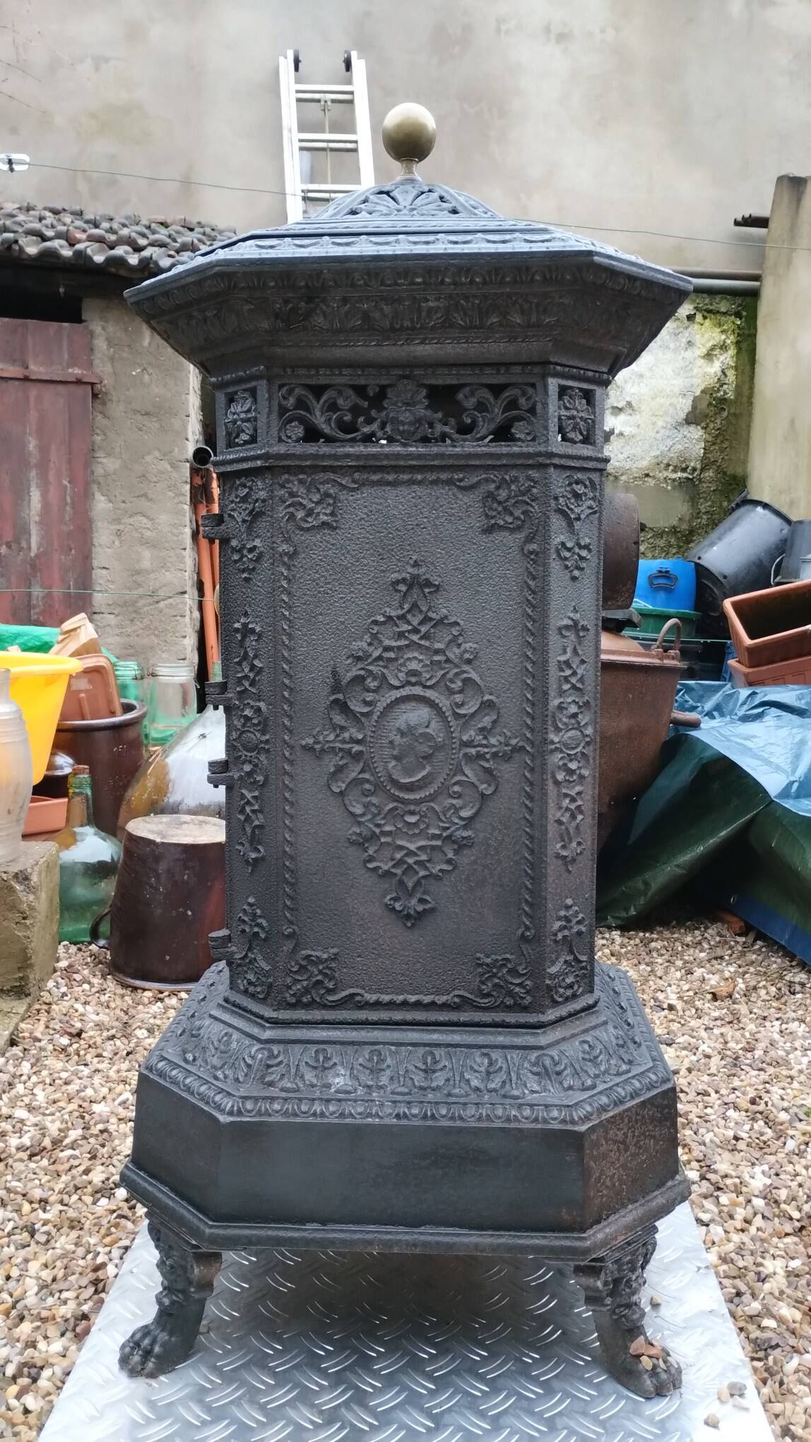 Black cast iron wood burning stove with solid brass handle.