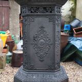 Black cast iron wood burning stove with solid brass handle.