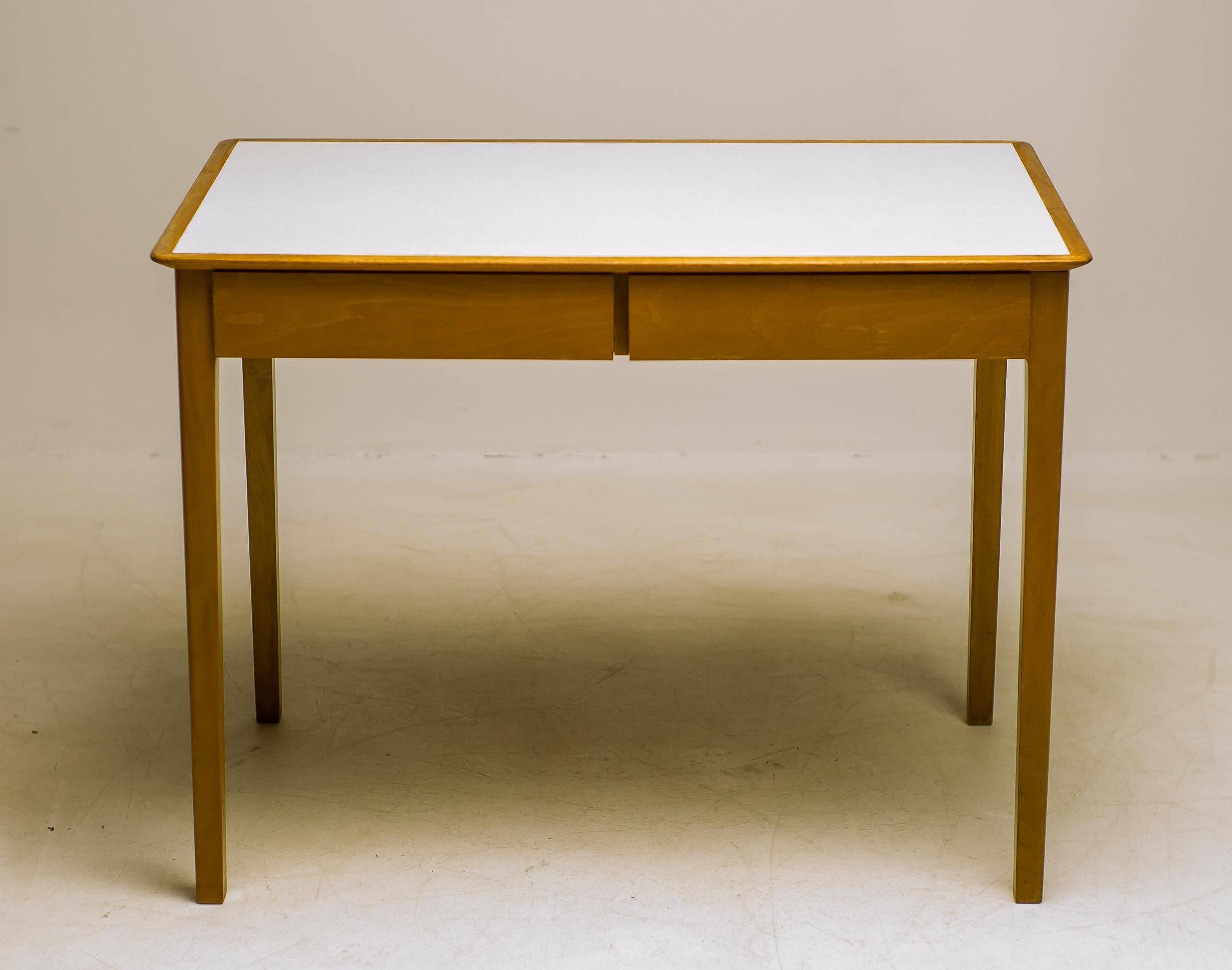 Small maple desk with a laminate top and two drawers, Fritz Hansen, 1950s.