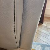 Two-seater sofa and a grey leather armchair Italia.