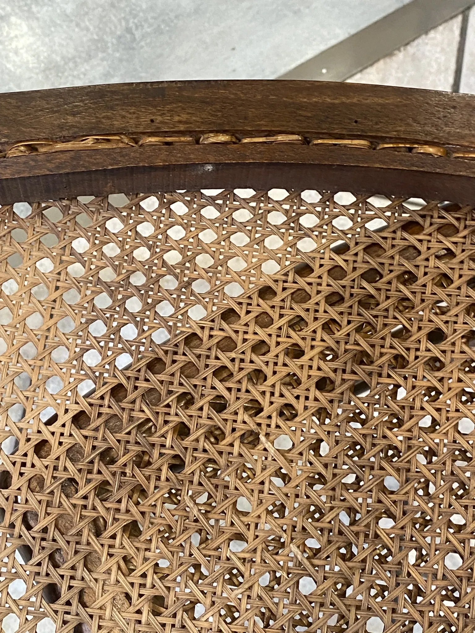 Pair of antique caned and wooden chairs from the 1900s.