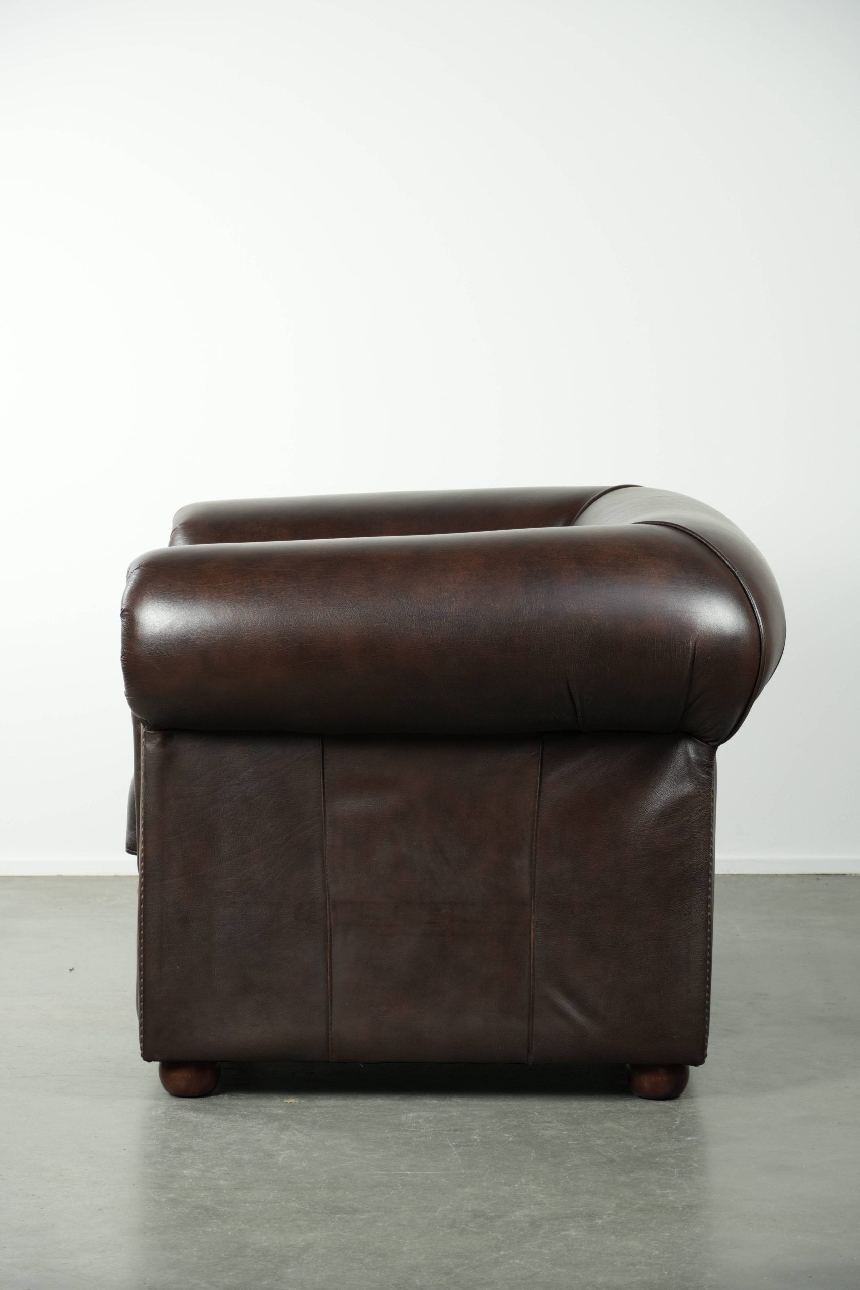 Luxury brown cow leather Chesterfield armchair with a timeless English look