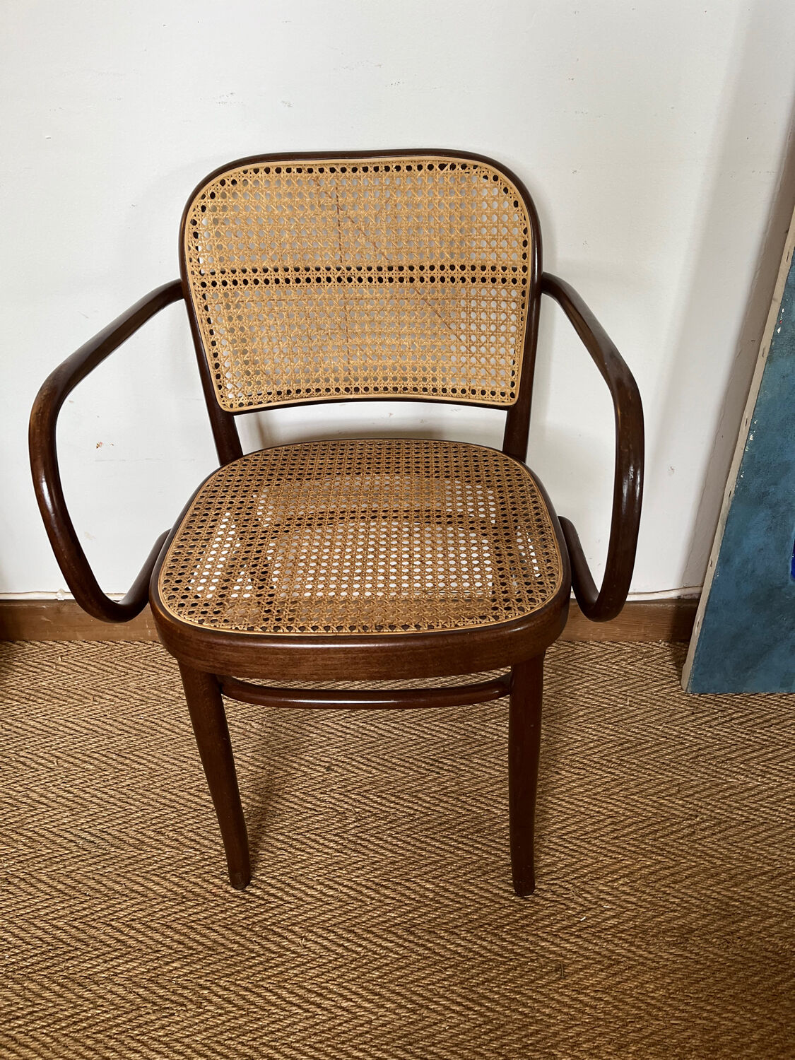 Curved wood and cane armchair
