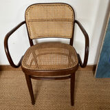 Curved wood and cane armchair