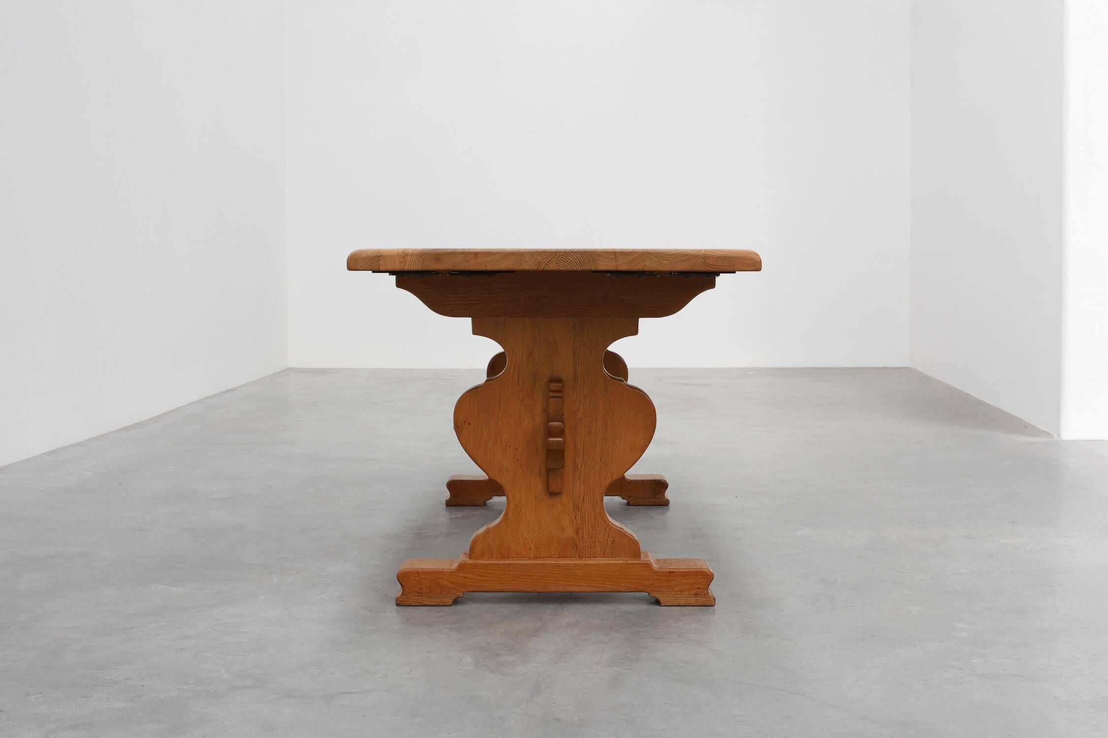 20th Century French oak trestle table with scalloped legs and plank top